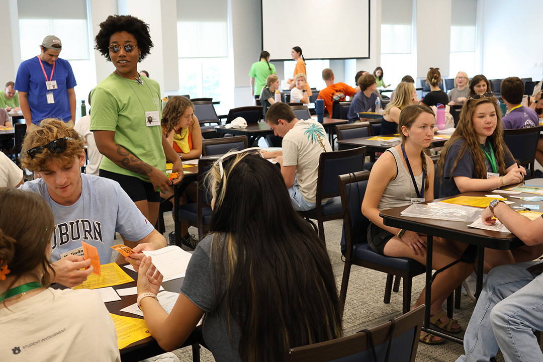 large groups of students at tables discussing 